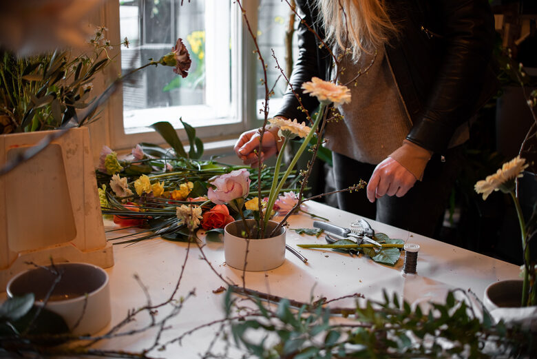 Flower arrangement workshop – a worktable with flowers and floristry tools