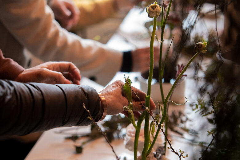 Participants create a flower arrangement in a workshop at the Dizaina Parks studio